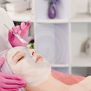 Cosmetician applying cream