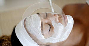 Cosmetician Applying Facial Mask