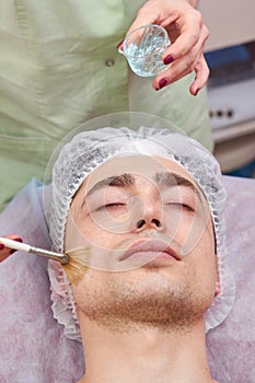 Cosmetician applying gel mask.