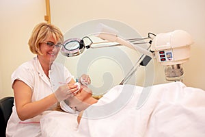 Cosmetician applying years of experience in a beauty skin treatment
