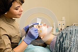 Cosmetician doctor applies nourishing mask