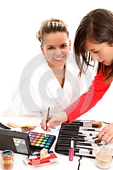 Cosmetician doing makeup photo