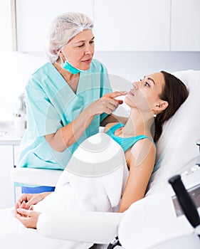 Cosmetician explaining treatment to patient