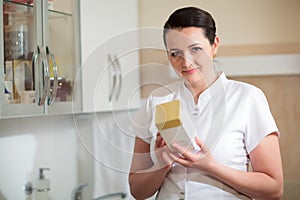 Cosmetician holding box with cosmetic