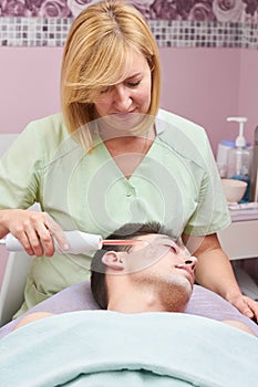 Cosmetician using darsonval device.