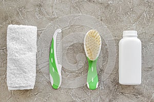 cosmetics for baby bath, towel and comb on gray background top view