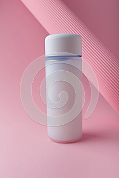 Cosmetics bottle mock up on pink background, blank label, no brand mock up. Cream refiner, shampoo, foam container for face skin photo