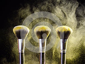 Cosmetics brush and explosion colorful makeup powder background - beauty make-up product and mineral cosmetic concept