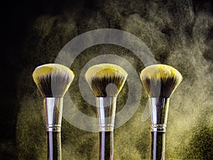 Cosmetics brush and explosion colorful makeup powder background - beauty make-up product and mineral cosmetic concept