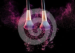 Cosmetics brush with powder explosion on black