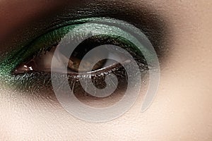 Cosmetics, close-up eye make-up. Fashion glitter green mint eyeshadow
