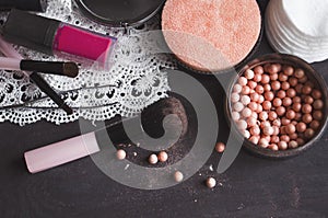 Cosmetics on a dark background, close-up. Face care, make-up. Items for applying makeup. The world of a woman