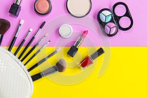 Cosmetics and fashion background with make up artist objects: lipstick, eye shadows, mascara ,eyeliner, concealer, nail polish.