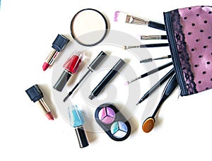 Cosmetics and fashion background with make up artist objects: lipstick, eye shadows, mascara ,eyeliner, concealer, nail polish.