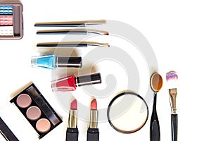 Cosmetics and fashion background with make up artist objects: lipstick, eye shadows, mascara ,eyeliner, concealer, nail polish.