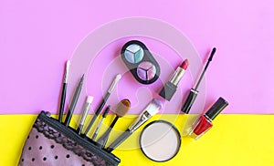 Cosmetics and fashion background with make up artist objects: lipstick, eye shadows, mascara ,eyeliner, concealer, nail polish