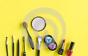 Cosmetics and fashion background with make up artist objects: lipstick, eye shadows, mascara ,eyeliner, concealer, nail polish.