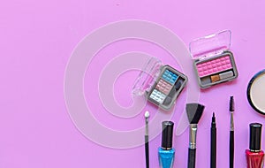 Cosmetics and fashion background with make up artist objects: lipstick, eye shadows, mascara ,eyeliner, concealer, nail polish.