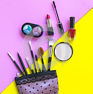 Cosmetics and fashion background with make up artist objects: lipstick, eye shadows, mascara ,eyeliner, concealer, nail polish