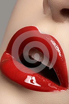 Cosmetics. Fashion bright red lips glossy make-up, clean skin