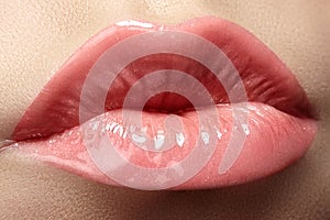 Cosmetics & lips. Macro of fashion lipgloss makeup in sweet kiss