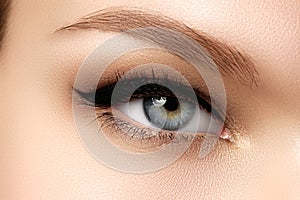 Cosmetics & make-up. Beautiful female eye with black liner