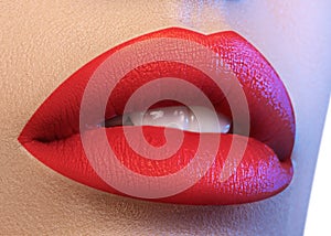 Cosmetics, makeup. Bright lipstick on lips. Closeup of beautiful female mouth with juicy red lip makeup. Part of face