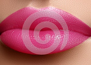 Cosmetics, makeup. Bright lipstick on lips. Closeup of beautiful female mouth with pink lip makeup. Sweet kiss