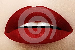 Cosmetics, makeup. Bright lipstick on lips. Closeup of beautiful female mouth with red lip makeup. Part of face