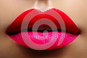 Cosmetics, makeup. Bright lipstick on lips. Closeup of beautiful female mouth with red and pink lip makeup. Part of face