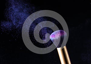 Cosmetics makeup brush and powder dust explosion.