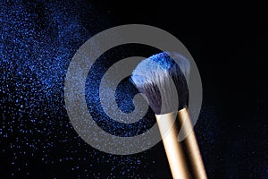 Cosmetics makeup brush and powder dust explosion.