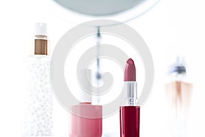 Cosmetics, makeup products on dressing vanity table, lipstick, foundation base, nailpolish and eyeshadows for luxury beauty and