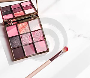 Cosmetics, makeup products set on marble vanity table, lipstick, eyeshadows and make-up brush for luxury beauty and fashion brand