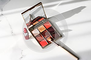 Cosmetics, makeup products set on marble vanity table, lipstick, eyeshadows and make-up brush for luxury beauty and fashion brand