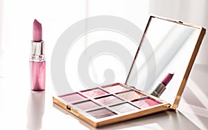 Cosmetics, makeup products set on marble vanity table, lipstick, eyeshadows and make-up brush for luxury beauty and fashion brand