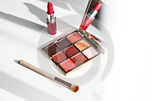 Cosmetics, makeup products set on marble vanity table, lipstick, eyeshadows and make-up brush for luxury beauty and fashion brand