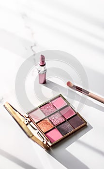 Cosmetics, makeup products set on marble vanity table, lipstick, eyeshadows and make-up brush for luxury beauty and fashion brand