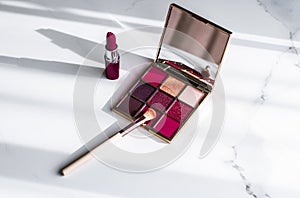 Cosmetics, makeup products set on marble vanity table, lipstick, eyeshadows and make-up brush for luxury beauty and fashion brand