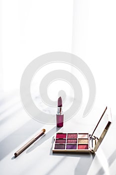 Cosmetics, makeup products set on marble vanity table, lipstick, eyeshadows and make-up brush for luxury beauty and fashion brand