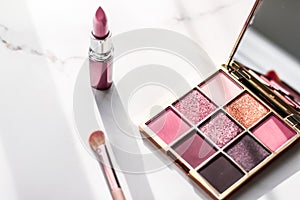 Cosmetics, makeup products set on marble vanity table, lipstick, eyeshadows and make-up brush for luxury beauty and fashion brand