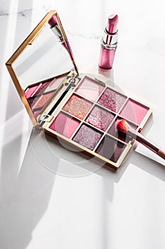 Cosmetics, makeup products set on marble vanity table, lipstick, eyeshadows and make-up brush for luxury beauty and fashion brand