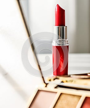 Cosmetics, makeup products set on marble vanity table, lipstick, eyeshadows and make-up brush for luxury beauty and fashion brand