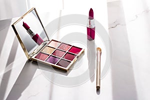 Cosmetics, makeup products set on marble vanity table, lipstick, eyeshadows and make-up brush for luxury beauty and fashion brand