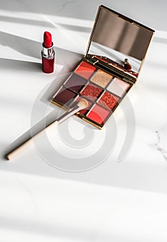 Cosmetics, makeup products set on marble vanity table, lipstick, eyeshadows and make-up brush for luxury beauty and fashion brand