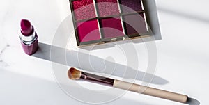 Cosmetics, makeup products set on marble vanity table, lipstick, eyeshadows and make-up brush for luxury beauty and fashion brand