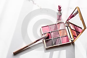 Cosmetics, makeup products set on marble vanity table, lipstick, eyeshadows and make-up brush for luxury beauty and fashion brand