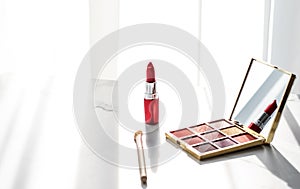 Cosmetics, makeup products set on marble vanity table, lipstick, eyeshadows and make-up brush for luxury beauty and fashion brand