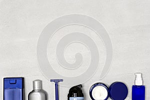 Cosmetics for men. Shaving and skincare products for man on concrete background. Copy space