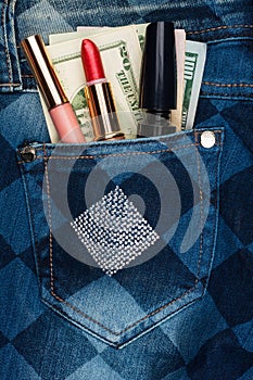 Cosmetics and money sticks out of the pocket of his jeans with r